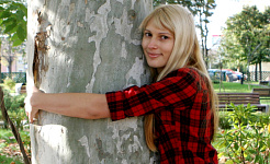 young woman hugging a tree
